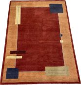 A Nepalese hand made wool rug with an abstract minimal block design over a burgundy field within a