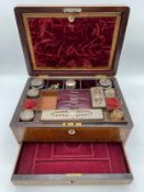 A 19th century rosewood dressing box with mother of pearl inlay, the lid opening to reveal a
