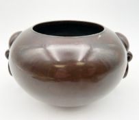 A Chinese bronze censer of compressed globular form with lobed loop and ring handles and a cast