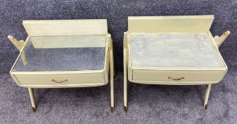 A pair of mid-century painted bedside tables each with an inset mirror top over a single frieze