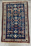 A Caucasian Perpedil wool rug with a repeating ram's horn pattern over a blue field with a