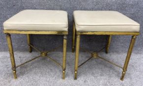 A pair of 19th century French gilt bronze stools with leather inset cushions over four stretchered