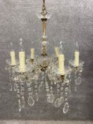 A cut glass and brass six-branch chandelier. H.87 Dia.54cm.
