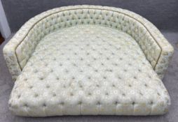 A large bespoke day bed with all over deep buttoned foliate upholstery on inset block supports. H.70