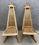 A pair of unusual mid-century reed and hardwood chairs of triangular form with a spindle shaped