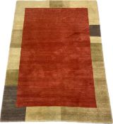 A hand made Nepalese rug with a burgundy central field within a tonally graduating border. H.240 W.