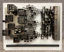 A mid-century abstract steel wall hanging sculpture on a white painted backing board by Robert de