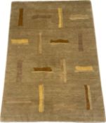 A hand made Nepalese wool rug with an alternating linear design in autumnal colours over a