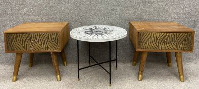 A pair of mango wood bedside tables each with a single frieze drawer clad in brass, with a repeating