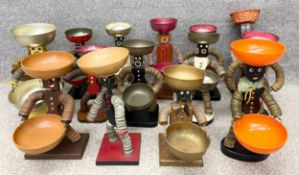 A collection of fifteen vintage American folk/tramp art bottle-cap figures sculpted using bottle