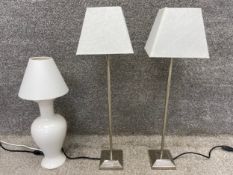A pair of contemporary chrome table lamps with shades, along with a ceramic baluster vase lamp