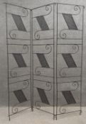 A mid-century wrought iron decorative folding screen/trellis with stylised scrolling motifs. H.183