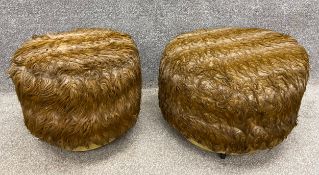 A pair of mid-century brass and faux fur stools on castors. H.42cm.
