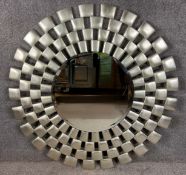 A contemporary moulded composite 'Laviana' sunburst mirror with a silver finish and a circular