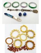 A collection of jadeite and other bangles along with other miscellaneous items. dia.7.5cm. Beads