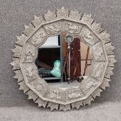 A carved and painted mirror, the central plate being surrounded by a moulded and scalloped edge
