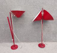 A pair of large mid-century industrial use red and white wall mounted metal lamps with one and two
