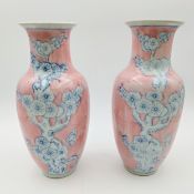 A pair of hand painted Oriental style vases of baluster form, with cherry blossoms in underglaze