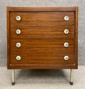 A mid-century teak chest of drawers on round metal supports. H.76 W.66 D.50cm.