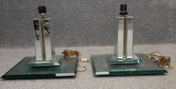 A pair of Art Deco mirrored glass and brass table lamps of pilaster form on a square stepped