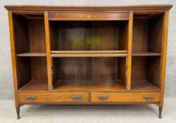 An Edwardian dwarf open bookcase with a moulded cornice and a satinwood marquetry frieze, above