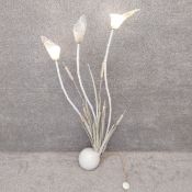 A mid-century steel floor lamp of naturalistic reed and bullrush form on a heavy spherical base,