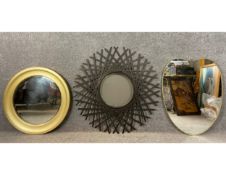 Three mirrors to include a contemporary circular gilt metal mirror with a bevelled plate, another