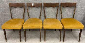 A set of four late 19th/early 20th century oak dining chairs of simple form having a shaped top rail