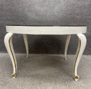 A vintage mirror topped coffee table on painted base with cabriole supports. H.54 Dia.93cm