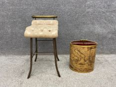 A late 19th/early 20th century small French music stool with a brass top rail over a buttoned damask