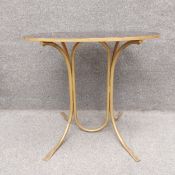 An Art Deco style occasional table with a simulated tortoiseshell oval resin top on gold painted