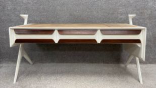 A mid-century Italian white painted desk/sideboard with three frieze drawers raised on splayed