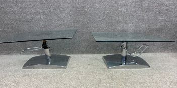 A pair of vintage chrome and glass coffee tables with adjustable height mechanisms. H.46cm (fully