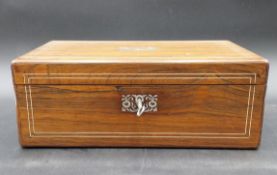 A 19th century rosewood writing box with mother of pearl inlay and a fitted interior with a baize