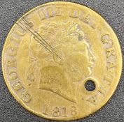 A George III 1818 gold half sovereign coin with a drilled hole as seen. Dia.3cm weight 11g.