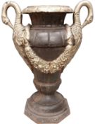 A Neoclassical style cast iron urn with twin gilt swan head handles and floral swags on a turned