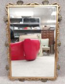 A mid-century Italian Art Deco style gilt effect metal wall hanging mirror with applied shell and