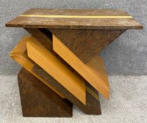 A mid-century Italian veneered console or centre table with a burr walnut top above a stylised