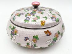 A Korean .99 silver and enamel round cloisonné box with a scrolling foliate and floral design with