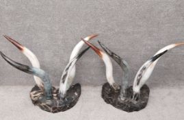A pair of horn console tables with metal collars on shaped simulated marble bases. (Missing plate