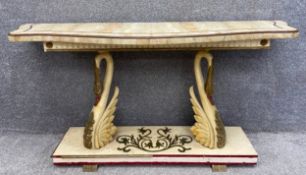 An Art Deco console table with an inlaid onyx serpentine fronted top over a fluted and gilt