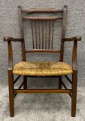 A C.1900 mahogany framed child's armchair with woven rush seat. H.77 W.51 D.50cm