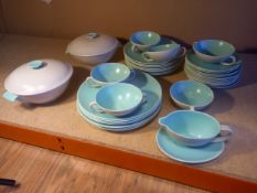 A Poole Twintone part dinner service comprising two lidded tureens, a sauce boat, six twin-handled