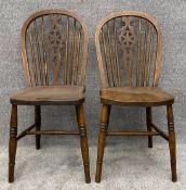 A pair of beech and elm Windsor wheelback dining chairs. H.88cm (each)