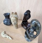 A mixed collection of stone and hardwood Eastern items to include an African pottery vase. H.25cm