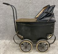 A Victorian black lacquered dolls pram/stroller. H.69 L.76 W.35cm