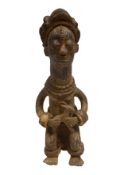 An African terracotta seated figure. H.47cm