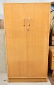 A mid century light oak G-Plan wardrobe or hall cupboard with maker's mark. H.176 W.92 D.53cm