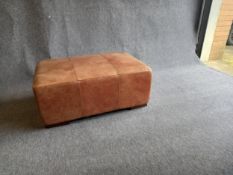 A tan leather footstool ottoman. 94x60x38cm