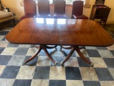 A C.1900 Georgian style mahogany twin pillar dining table with two extra leaves. Leaves supported by